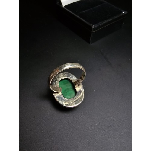 268 - A stunning 925 silver statement ring inset with a large oval malachite stone presenting an excellent... 