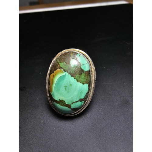 269 - A large 925 silver statement ring inset with a large oval chrysocola stone (a combination of malachi... 