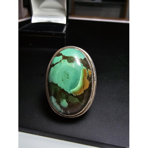 269 - A large 925 silver statement ring inset with a large oval chrysocola stone (a combination of malachi... 