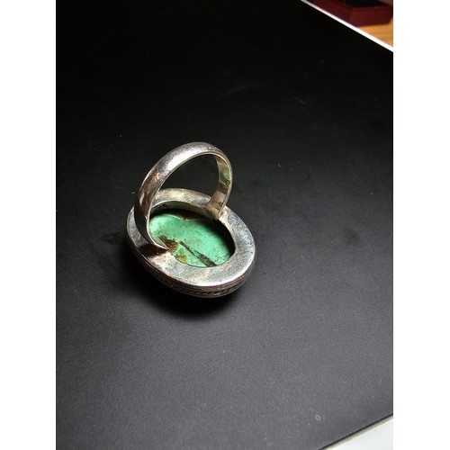 269 - A large 925 silver statement ring inset with a large oval chrysocola stone (a combination of malachi... 