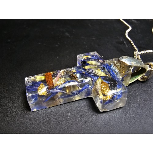 273 - An unusual cross pendant made out of resin inset with real dried flowers and gold leaf set on a 925 ... 