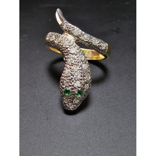 274 - An ornate gold and 925 silver snake formed ring featuring a gold plated silver band , the snake is i... 