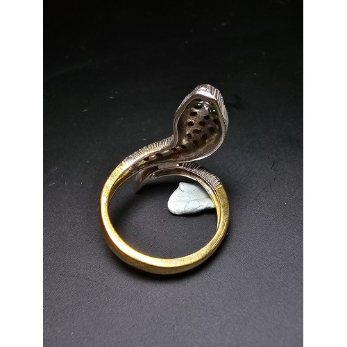 274 - An ornate gold and 925 silver snake formed ring featuring a gold plated silver band , the snake is i... 