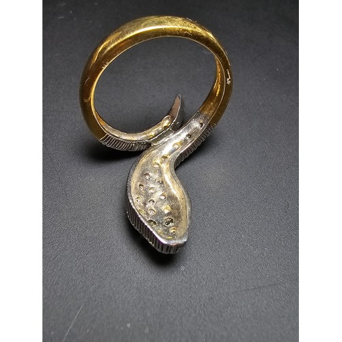 274 - An ornate gold and 925 silver snake formed ring featuring a gold plated silver band , the snake is i... 