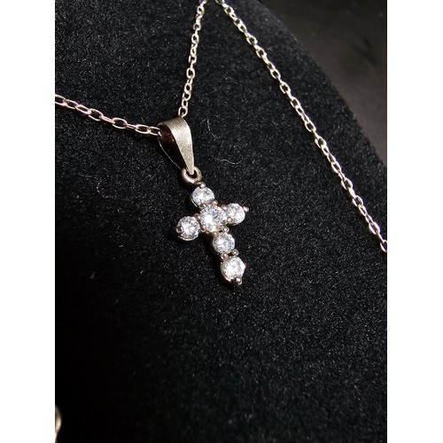 276 - A pretty small 925 silver cross pendant inset with 6 sparkly cz crystal stones set on a 16