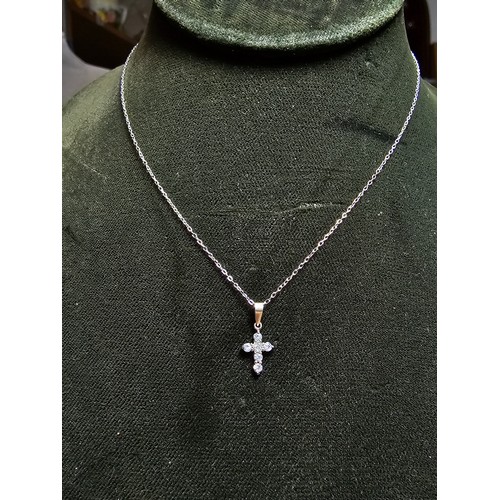 276 - A pretty small 925 silver cross pendant inset with 6 sparkly cz crystal stones set on a 16