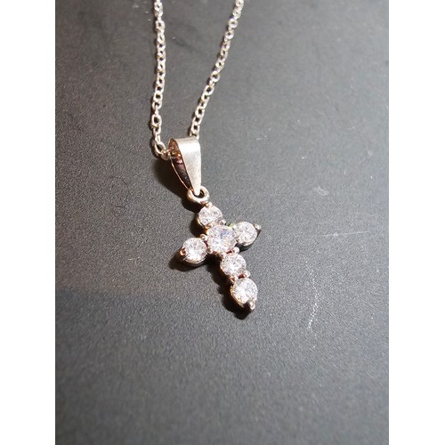 276 - A pretty small 925 silver cross pendant inset with 6 sparkly cz crystal stones set on a 16