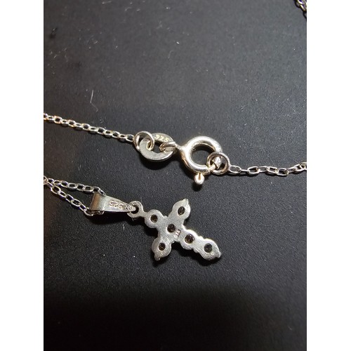 276 - A pretty small 925 silver cross pendant inset with 6 sparkly cz crystal stones set on a 16