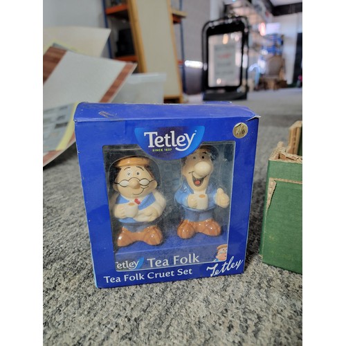 393 - A collection of vintage Tetley tea items including 2 teapots, cookie jar, toast rack, etc.