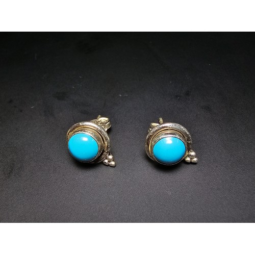 282 - A pair of pretty 925 silver stud earrings inset with blue turquoise cabochon stones, complete with b... 