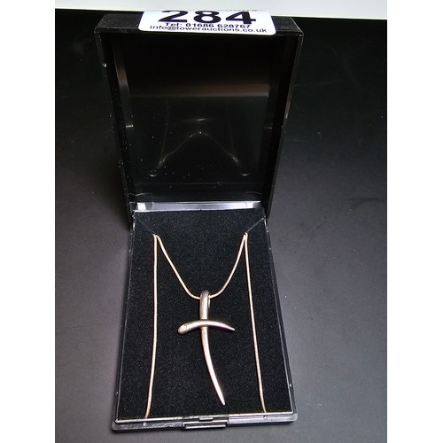 284 - A 925 silver cross pendant inset with a .016ct diamond set on a good 18