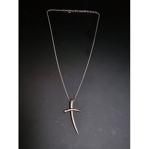 284 - A 925 silver cross pendant inset with a .016ct diamond set on a good 18