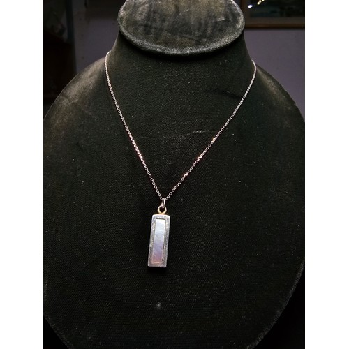 286 - A chunky 925 silver bar pendant inset with mother of pearl and having good flashing colours set on a... 