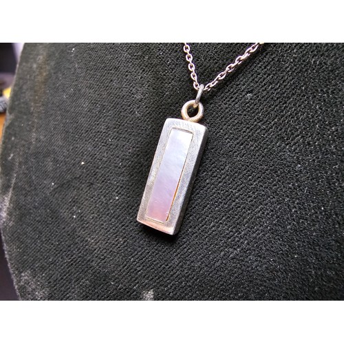 286 - A chunky 925 silver bar pendant inset with mother of pearl and having good flashing colours set on a... 