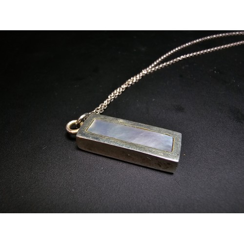 286 - A chunky 925 silver bar pendant inset with mother of pearl and having good flashing colours set on a... 