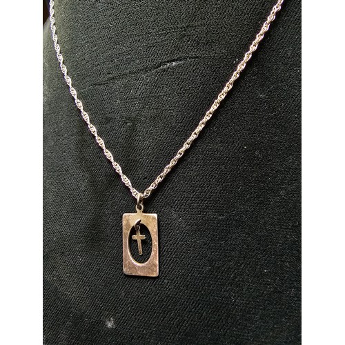 295 - A 925 silver pendant featuring a dangling cross within a silver frame set on a good 16