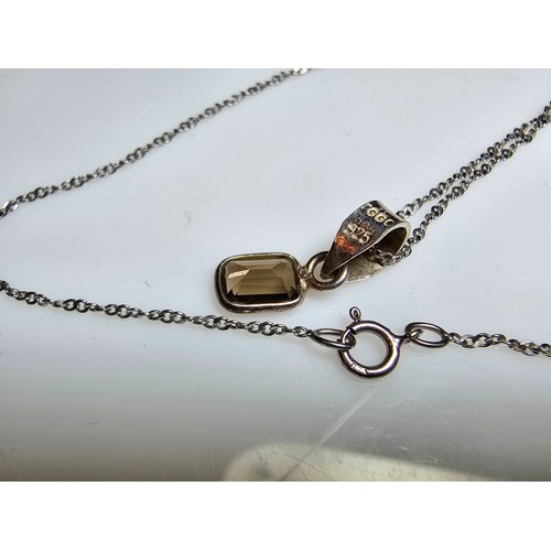 296 - An as new 925 silver pendant inset with a good faceted smokey quartz gemstone set on a long 18