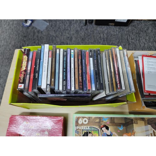 401 - A selection of jigsaw puzzles and games along with a selection of Cd's. To include a Waddingtons spo... 