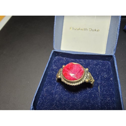 301 - 3 boxed costume jewellery items which includes an ornate dress ring inset with a large natural ruby ... 