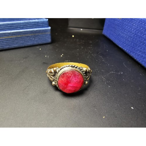 301 - 3 boxed costume jewellery items which includes an ornate dress ring inset with a large natural ruby ... 