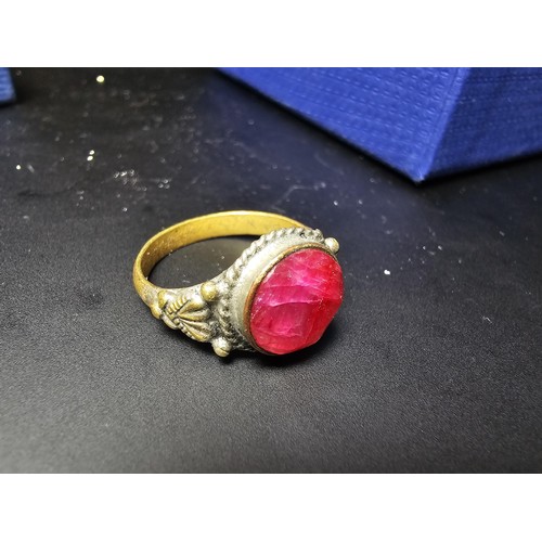 301 - 3 boxed costume jewellery items which includes an ornate dress ring inset with a large natural ruby ... 