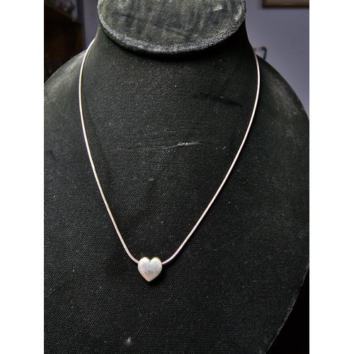 302 - A pretty 925 silver necklace with a heart pendant. Necklace is 16