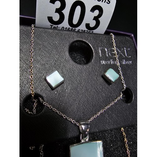 303 - An as new 925 silver matching jewellery set by NEXT which includes a necklace and earrings inset wit... 