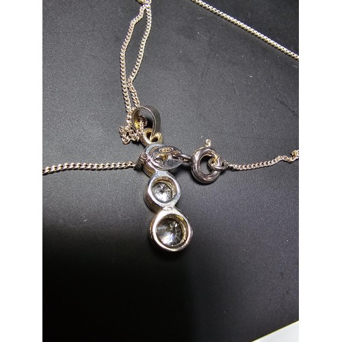 304 - A 925 silver pendant inset with 3 large sparkly crystal cz stones set on an 18