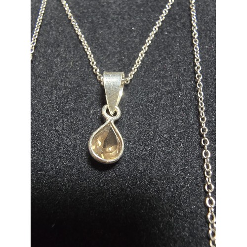 306 - An as new 925 silver pendant and chain. The pendant is inset with a natural faceted smokey quartz st... 