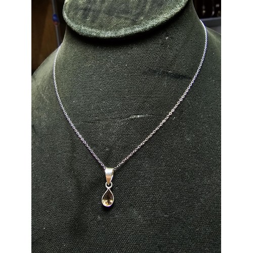 306 - An as new 925 silver pendant and chain. The pendant is inset with a natural faceted smokey quartz st... 