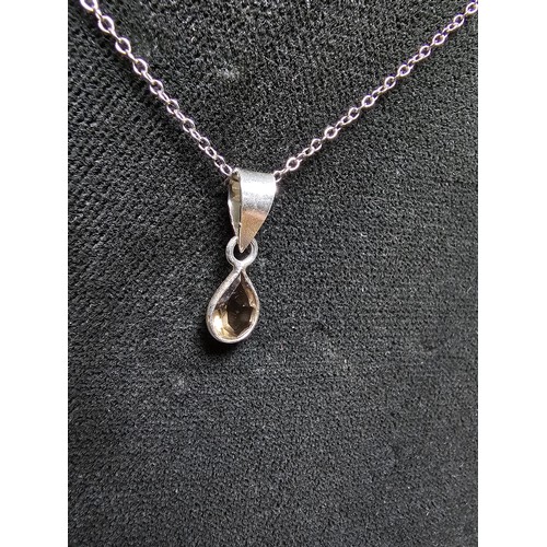 306 - An as new 925 silver pendant and chain. The pendant is inset with a natural faceted smokey quartz st... 