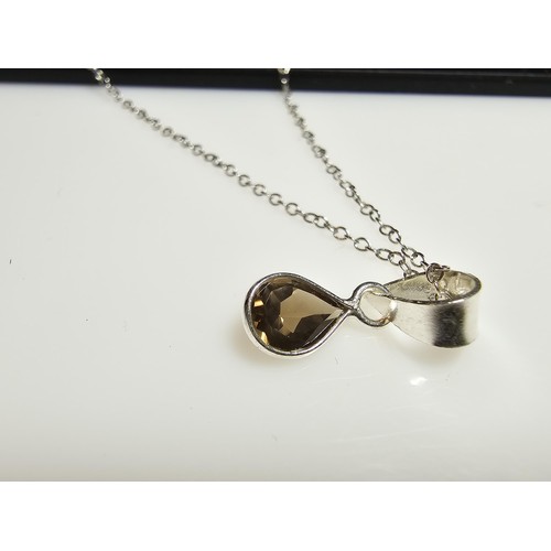 306 - An as new 925 silver pendant and chain. The pendant is inset with a natural faceted smokey quartz st... 