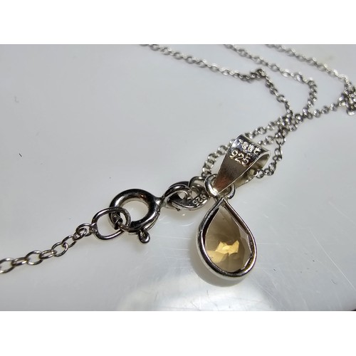 306 - An as new 925 silver pendant and chain. The pendant is inset with a natural faceted smokey quartz st... 