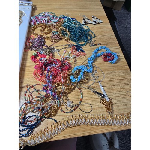 310 - A basket of various costume jewellery to include some good statement pieces, a long 30