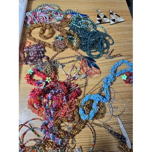 310 - A basket of various costume jewellery to include some good statement pieces, a long 30