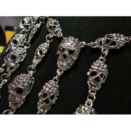 311 - An unusual silver tone ornate necklace featuring a large quantity of skull and cross drops. Beautifu... 