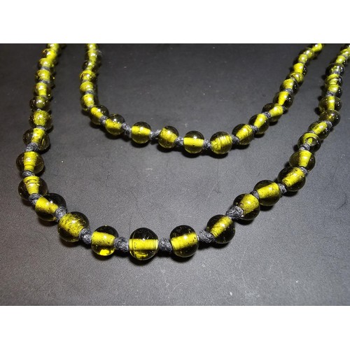 312 - A good vintage hand knotted long green art glass beaded necklace in excellent clean condition and di... 