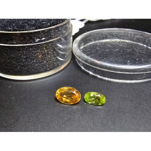 318 - A cased set of 2 good faceted loose gemstones to include a natural citrine gemstone (7mm x 4mm) and ... 