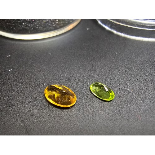 318 - A cased set of 2 good faceted loose gemstones to include a natural citrine gemstone (7mm x 4mm) and ... 