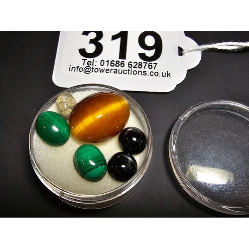 319 - A collection of 6 various polished loose gemstones which includes a good quality tigers eye oval sto... 