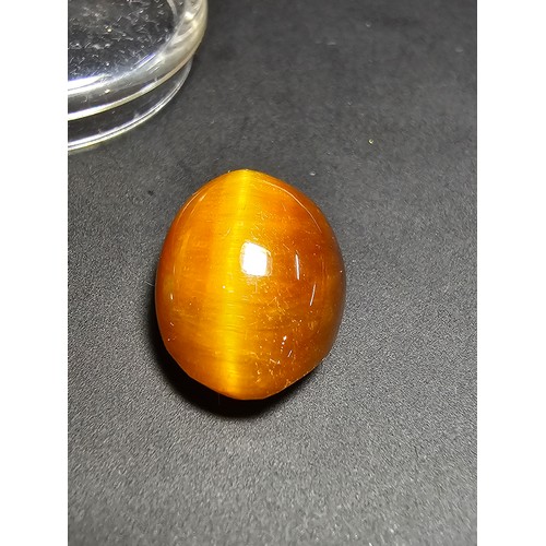 319 - A collection of 6 various polished loose gemstones which includes a good quality tigers eye oval sto... 