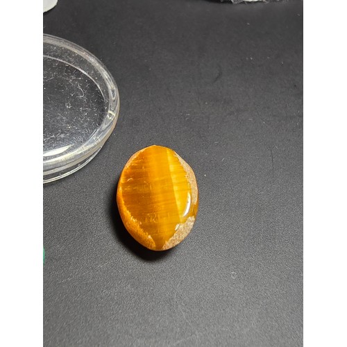 319 - A collection of 6 various polished loose gemstones which includes a good quality tigers eye oval sto... 