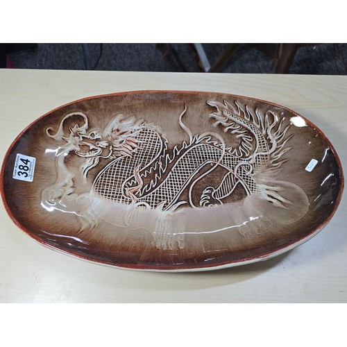 384 - Large and impressive terracotta pottery glazed charger with an incised dragon design by Campden Pott... 