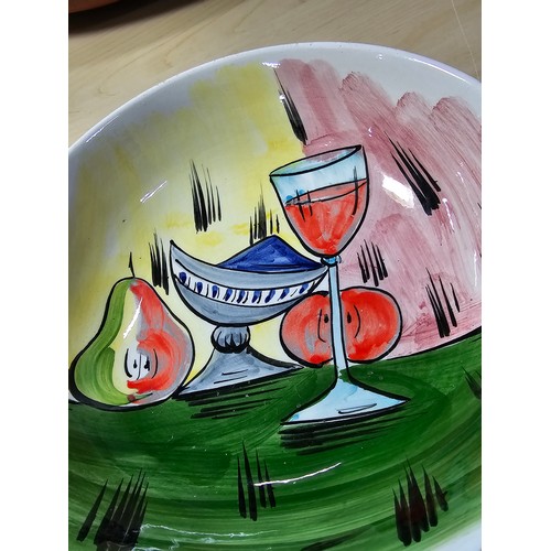 384A - An attractive vintage hand painted bowl with a wine glass and fruit design marked to the base made I... 