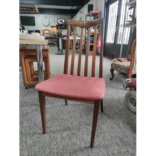 454 - Retro teak G-plan gate leg table and four solid chairs with pink upholstered seats. The chairs do ne... 