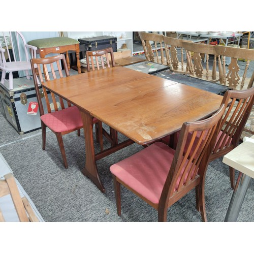 454 - Retro teak G-plan gate leg table and four solid chairs with pink upholstered seats. The chairs do ne... 