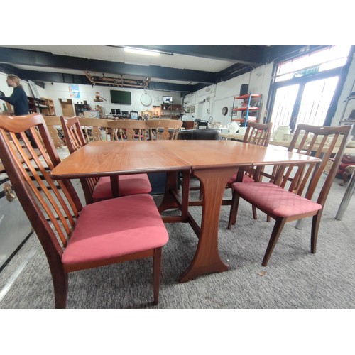 454 - Retro teak G-plan gate leg table and four solid chairs with pink upholstered seats. The chairs do ne... 