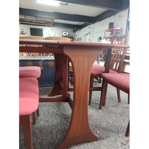 454 - Retro teak G-plan gate leg table and four solid chairs with pink upholstered seats. The chairs do ne... 