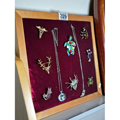 209 - Good quality display board (included) containing a quantity of brooches inc an enamel turtle, silver... 