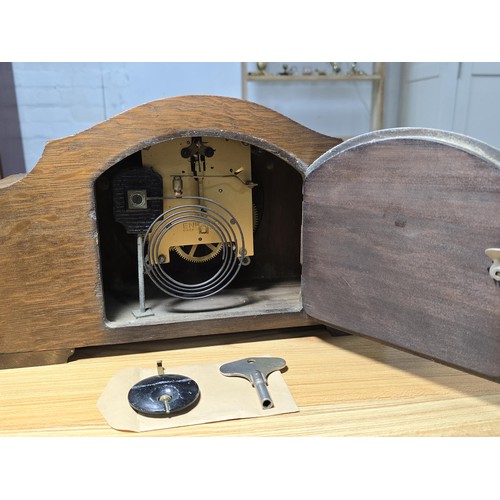 280 - A vintage oak mantel clock with an unusual pierced dial having an Enfield 8 day movement and complet... 